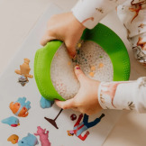 Zielony SENSORYCZNY DYSK Z FIGURKAMI A-Ku-Ku! Peekaboo, motyw Farma Jellystone 18m+